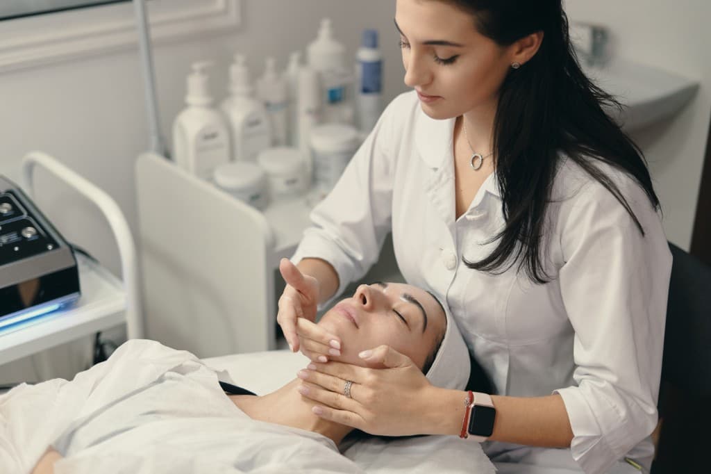 Clinician performing a relaxing facial massage during treatment