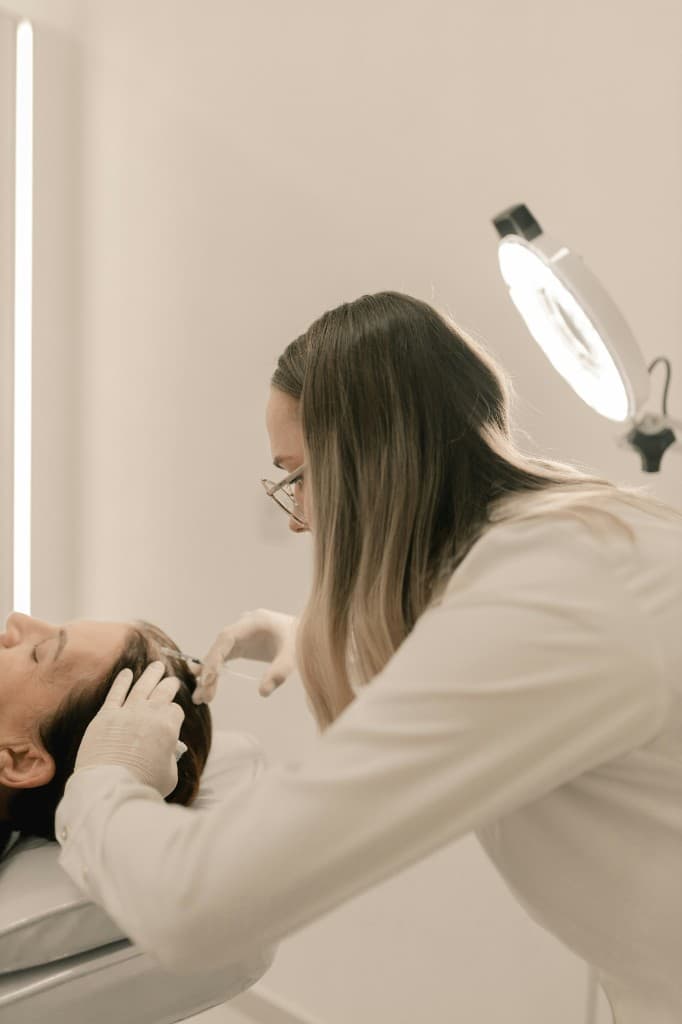 Doctor performing a precision aesthetic treatment